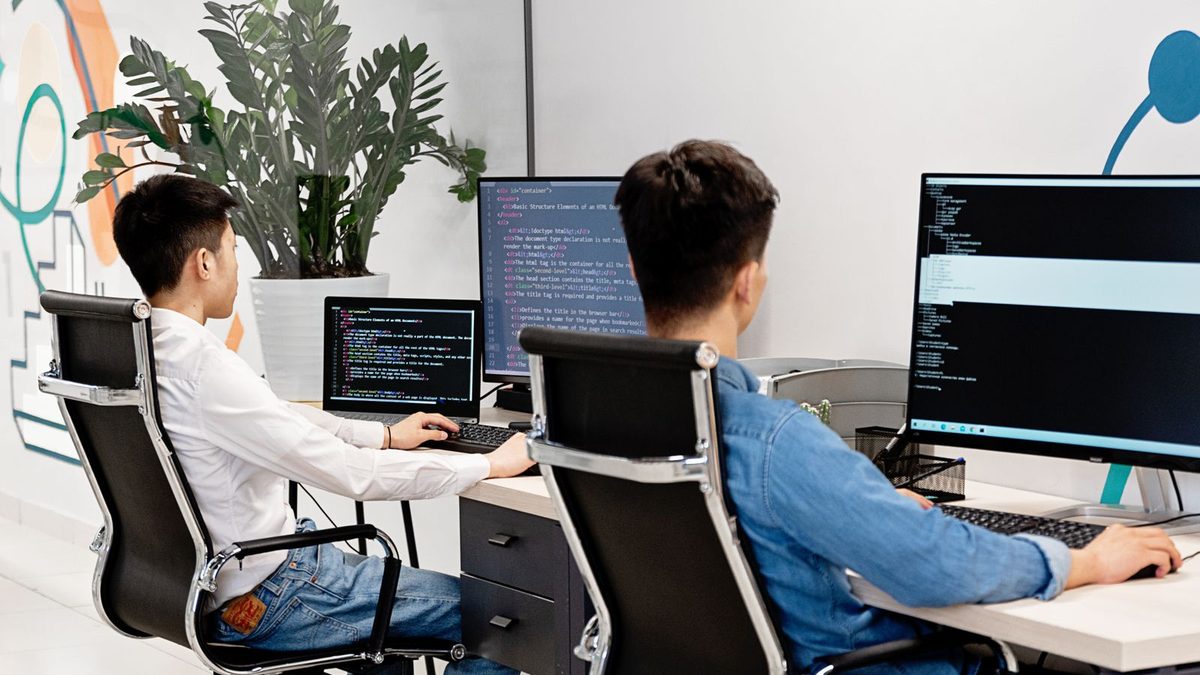 Two developers working at their monitors
